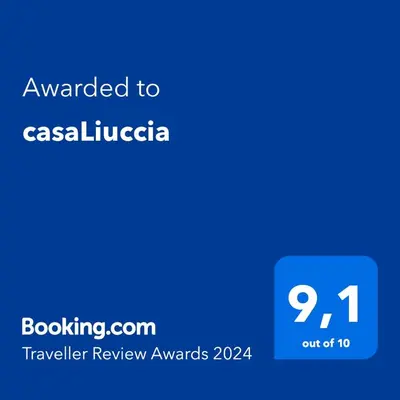 a blue text box with the words awarded to caselica at casaLiuccia in Mondello