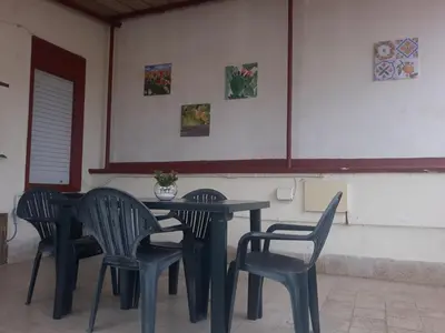a black table and chairs in a restaurant at casaLiuccia in Mondello