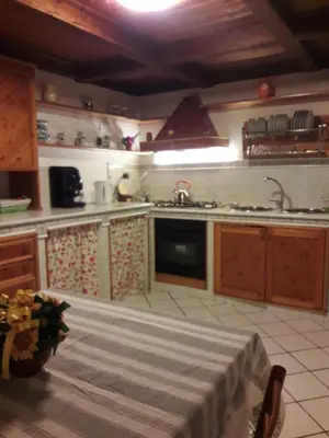 a kitchen with a sink and a stove top oven at Casa de Spuches in Palermo