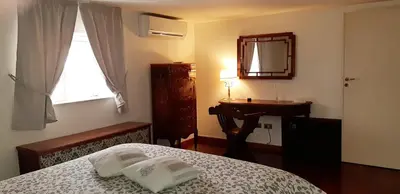 a bedroom with a bed and a sink and a mirror at Casa de Spuches in Palermo