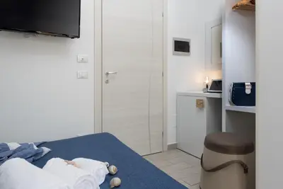 a bedroom with a bed with a teddy bear on it at B&B Reset confort & relax in San Vito lo Capo