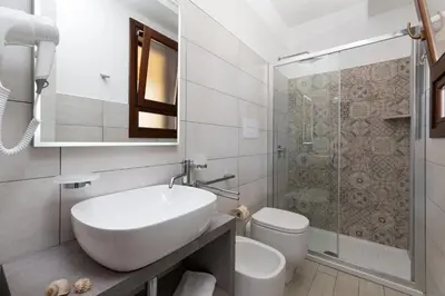 a bathroom with a sink and a toilet and a shower at B&B Reset confort & relax in San Vito lo Capo