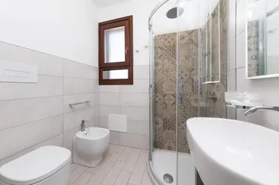 a bathroom with a toilet and a sink and a shower at B&B Reset confort & relax in San Vito lo Capo