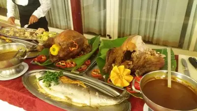 a table with a plate of food on a table at Hotel Torre Normanna in Altavilla Milicia