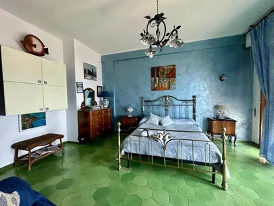 a bedroom with a bed and a chandelier at Sea Pearl in Casteldaccia