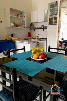 a table with a bowl of fruit on it in a kitchen at Casa Marisa in Palermo