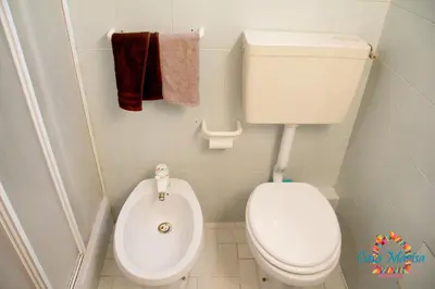 a small bathroom with a toilet and a bidet at Casa Marisa in Palermo