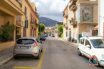 two cars parked on the side of a street at Casa Marisa in Palermo