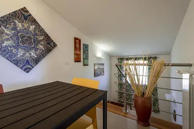 a dining room with a table and a vase at Borgo Aranci - Appartamento in Villa Rosa - 16B in Castellammare del Golfo