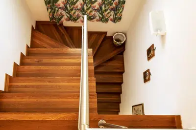 a spiral staircase in a home with wooden floors at Borgo Aranci - Appartamento in Villa Rosa - 16B in Castellammare del Golfo