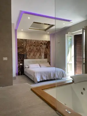 a bedroom with a bed and a tub in a room at Cannatella's Mansion in Palermo