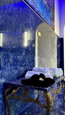 a bathroom with a table with a mirror and towels at Cannatella's Mansion in Palermo