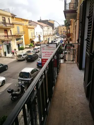 a view of a city street with cars parked at Si Viaggiare Apartments in Partinico