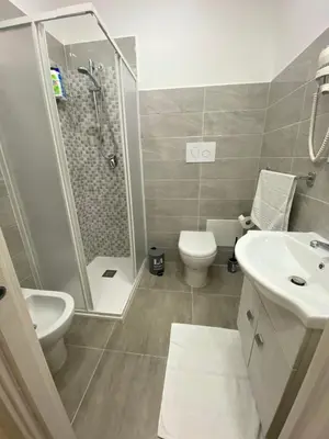 a bathroom with a shower and a toilet and a sink at Si Viaggiare Apartments in Partinico