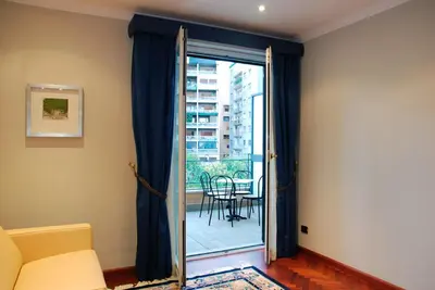 a living room with a sliding glass door to a patio at Hotel Giardino Inglese in Palermo