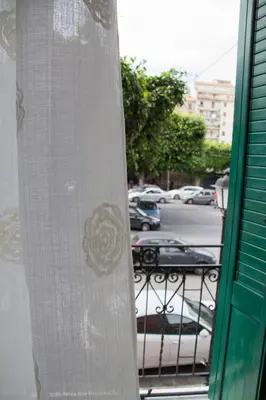 a surfboard standing on a balcony with a parking lot at Monte Palace Palermo in Palermo
