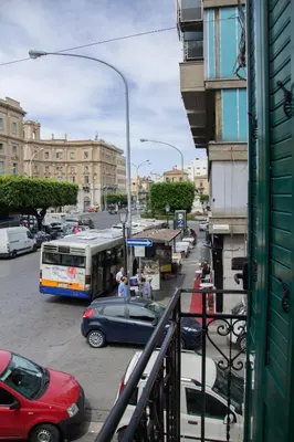 a busy city street with cars and a bus at Monte Palace Palermo in Palermo