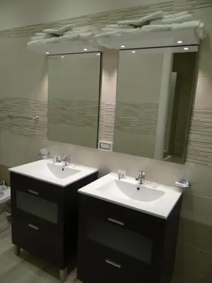 a bathroom with two sinks and a large mirror at Monte Palace Palermo in Palermo