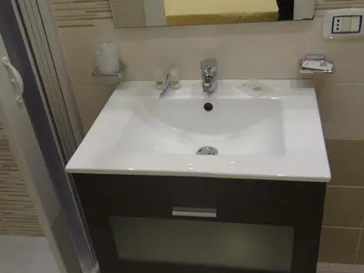 a bathroom with a white sink and a mirror at Monte Palace Palermo in Palermo