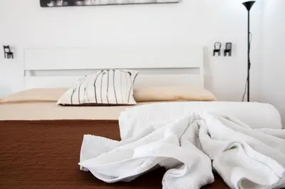 a bed with white towels laying on top of it at Fuga Romantica vicino al Mare - Rental BeB in Balestrate