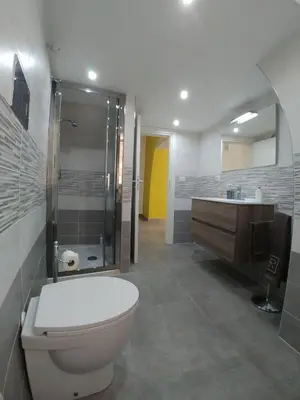 a bathroom with a toilet and a shower and a sink at Cassaro Antico in Palermo