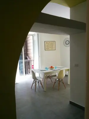 a dining room with a white table and chairs at Cassaro Antico in Palermo