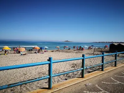 a group of people on a beach with umbrellas at Casa Siciliabedda in Capaci