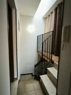a hallway with stairs and a white wall at Casa Trinita in Castellammare del Golfo