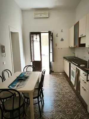 a kitchen with a table and chairs in a room at Casa Trinita in Castellammare del Golfo