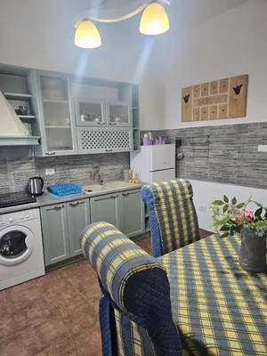 a kitchen with a table and chairs in a kitchen at Casa Marta in Palermo