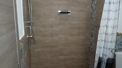 a bathroom with a shower with a shower curtain at Casa Marta in Palermo