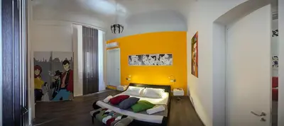 a bedroom with a bed and a yellow wall at Palermo Gallery in Palermo