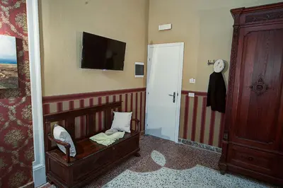 a room with a crib and a tv on the wall at Palermo Gallery in Palermo