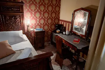 a bedroom with a bed and a mirror and a dresser at Palermo Gallery in Palermo
