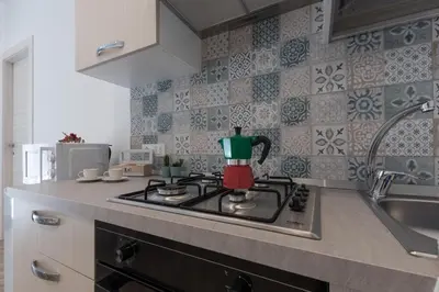 a kitchen with a tea kettle on a stove at Rugiada Home Castellammare del Golfo in Castellammare del Golfo