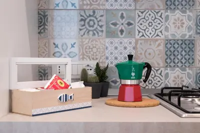 a kitchen counter with a coffee maker on a counter top at Rugiada Home Castellammare del Golfo in Castellammare del Golfo
