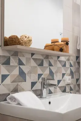 a bathroom with a sink and a mirror at Rugiada Home Castellammare del Golfo in Castellammare del Golfo