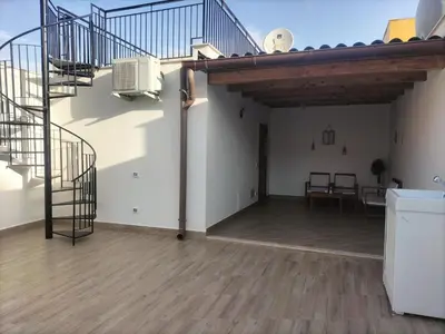 an empty room with a staircase and a table at Rugiada Home Castellammare del Golfo in Castellammare del Golfo