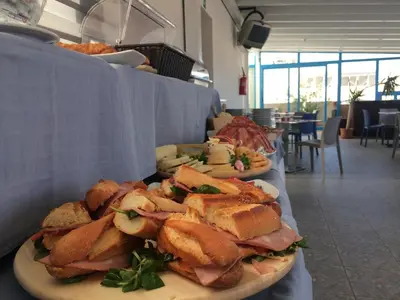 a group of sandwiches on plates on a table at Hotel Trinacria in San Vito lo Capo