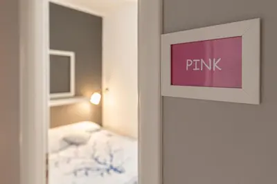 a door to a bedroom with a pink sign on it at B&B Montecarlo in Palermo