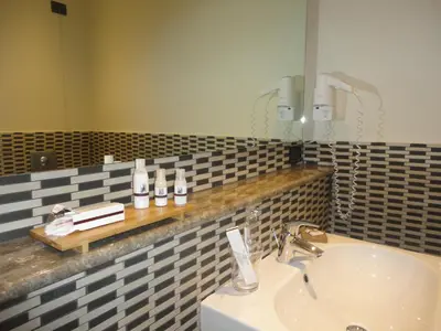 a bathroom with a sink and a mirror at BB 10 Serpotta - Palazzo Riolo & Restaurant in Palermo
