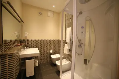a bathroom with a toilet and a sink and a shower at BB 10 Serpotta - Palazzo Riolo & Restaurant in Palermo