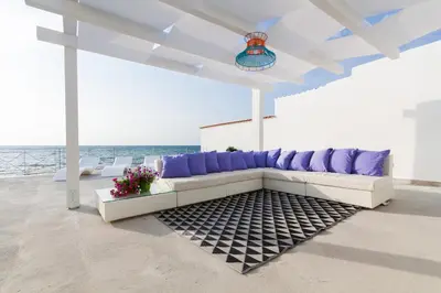 a living room with a couch and purple pillows at Marina Beach Resort by Le Dhome Sicily in Balestrate