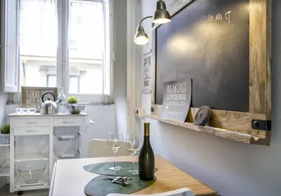 a table with two wine glasses and a chalkboard at Palazzo Filangeri di Amorosa in Palermo