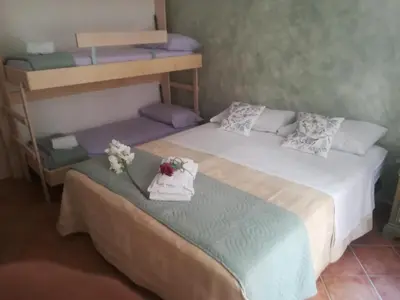 a bedroom with two bunk beds with flowers on the bed at La casetta alla Vucciria in Palermo