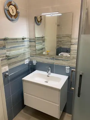 a bathroom with a sink and a mirror at Casa Del Mulino a Vento in San Vito lo Capo