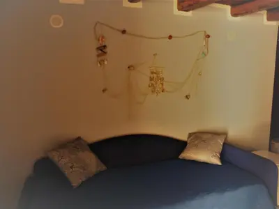 a bedroom with a blue bed with two pillows at A Vanedda in Termini Imerese