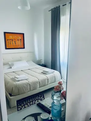 a bedroom with a bed and a desk with a computer at Casa Sciuti in Palermo