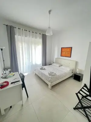 a bedroom with a bed and a table and a chair at Casa Sciuti in Palermo