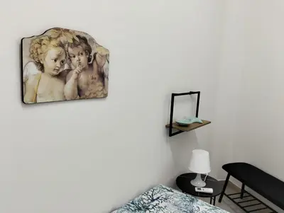 a painting of two children on a wall at Casa Le Bellezze del Golfo in Castellammare del Golfo